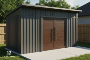 Modern dark gray metal shed with flat roof and brown double doors, located in a fenced backyard.
