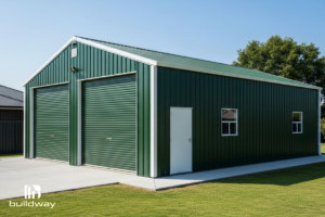 Green steel garage building with a high ceiling and white doors, located in a residential area.