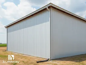 Light gray I-beam steel structure with side downspout system for efficient rainwater management.