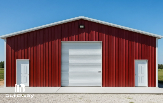 Red steel I-beam building with a large roll-up door and two entry doors, showcasing Buildway’s durable and versatile metal structures for workshops or storage.