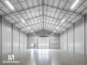Interior of an insulated cold-formed steel (CFS) building showing a clean, bright space with insulated walls and ceiling panels.