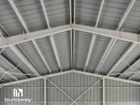 Close-up view of insulated steel roof panels and framing inside a Buildway I-beam structure for temperature control and durability.