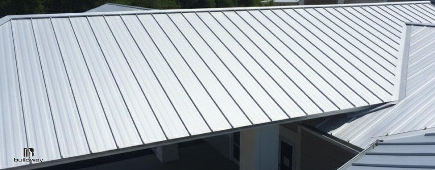 How Does Buildway’s 50-Year Rust Warranty Work and Is It Worth It? 2 Standing seam coated steel roof panels installed on a building.